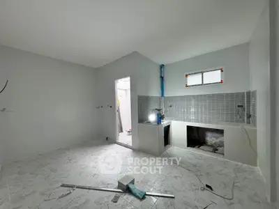 Spacious unfinished kitchen with tiled backsplash and ample natural light