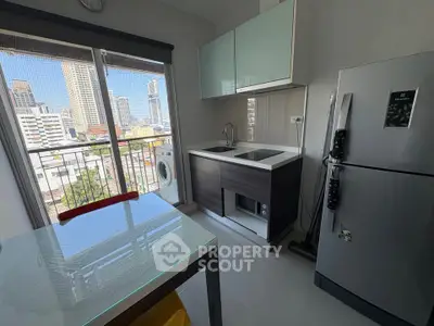 Modern kitchen with city view, featuring sleek appliances and a compact layout, perfect for urban living.