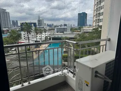 Urban balcony with cityscape view and pool, perfect for modern living.