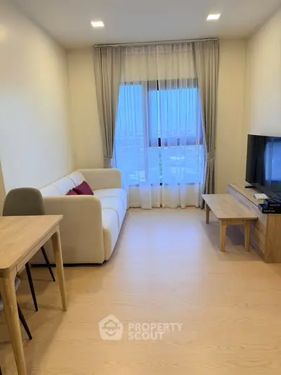 Modern living room with cozy sofa, TV, and large window with city view.