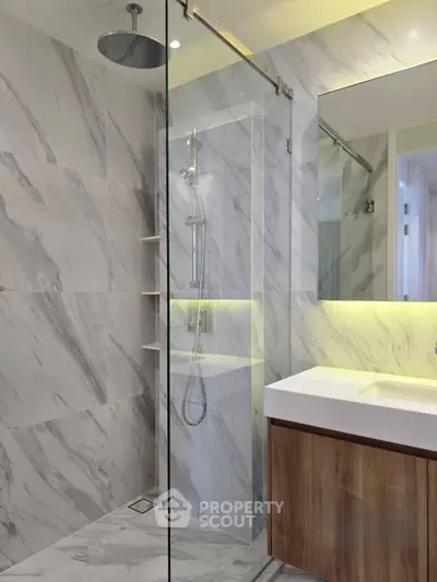 Luxurious modern bathroom with marble tiles and sleek shower design