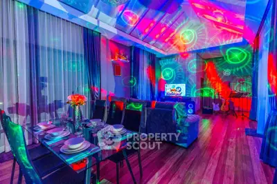 Vibrant living room with colorful lighting, modern furniture, and entertainment setup, perfect for hosting gatherings.