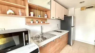 Modern kitchen with sleek cabinetry, built-in appliances, and stylish decor accents.