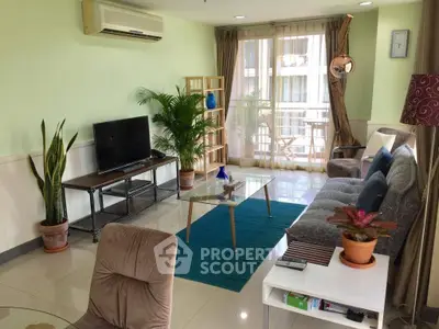 Spacious living room with modern decor and balcony access in a stylish apartment.