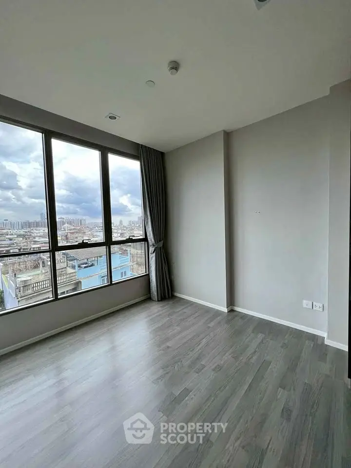 Spacious corner unit with large windows offering a stunning city view, perfect for modern living.
