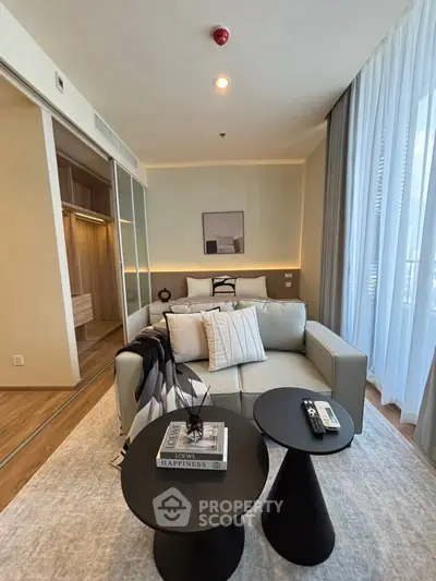 Modern living room with stylish decor and cozy ambiance, featuring a comfortable sofa and elegant coffee tables.