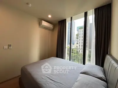 Cozy bedroom with city view and modern air conditioning unit