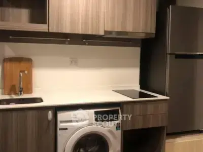 Modern kitchen with washing machine and sleek cabinetry