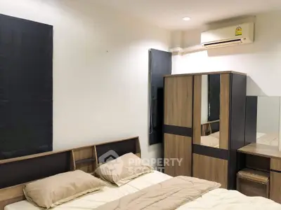 Cozy bedroom with modern wooden furniture and air conditioning