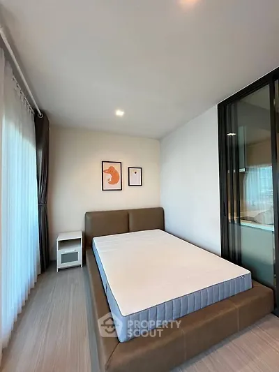 Modern bedroom with stylish decor and large window for natural light