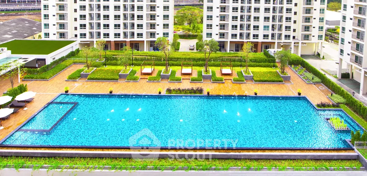 Luxurious apartment complex with a stunning outdoor pool and lush greenery.