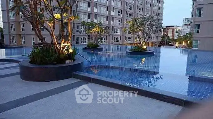 Luxurious apartment complex with stunning rooftop pool and lush greenery.