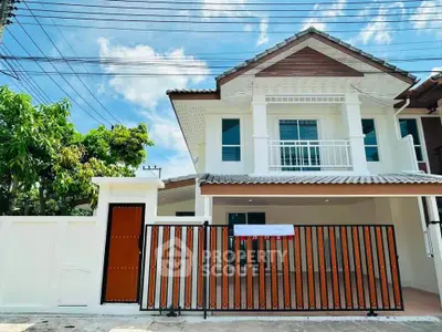 Charming two-story house with modern facade and gated entrance in a serene neighborhood.