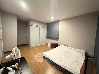 Spacious bedroom with modern decor and ample storage space