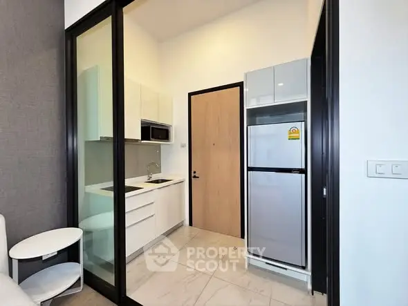 Modern compact kitchen with sleek appliances and minimalist design