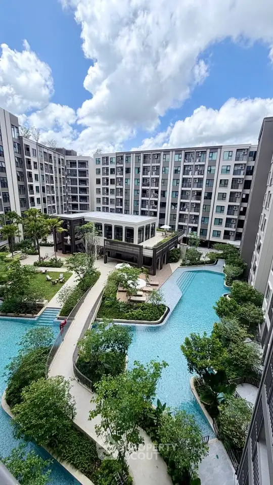 Luxurious condominium with stunning pool and lush garden view