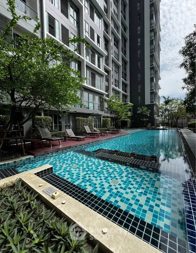 Luxurious condominium with stunning outdoor pool and lush greenery, perfect for relaxation and leisure.
