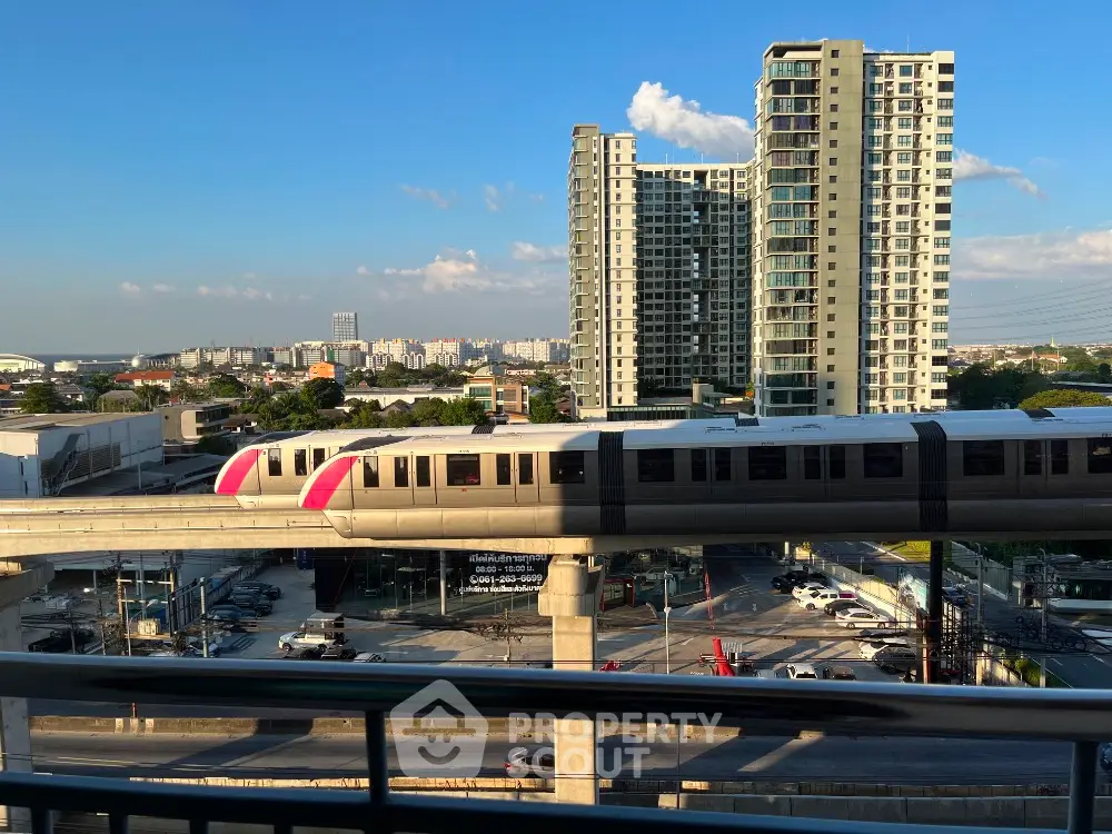 Stunning urban view with modern high-rise buildings and city train, perfect for city living enthusiasts.