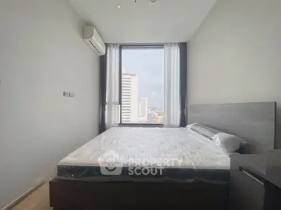 Modern bedroom with large window offering city view, featuring a sleek bed and air conditioning.