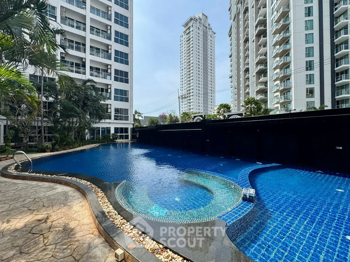 Luxurious apartment complex with stunning pool and modern high-rise buildings.