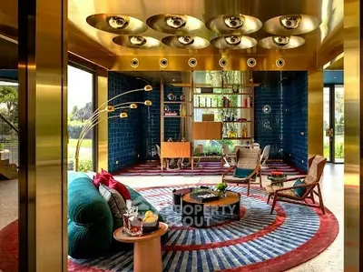 Luxurious living room with modern decor and vibrant colors, featuring unique lighting and stylish furniture.