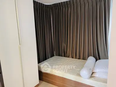 Cozy bedroom with modern design and elegant curtains, perfect for relaxation and comfort.
