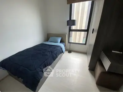 Cozy bedroom with single bed and modern furnishings, perfect for a minimalist lifestyle.
