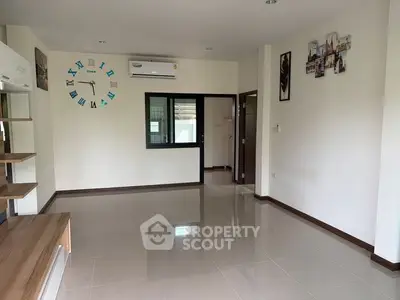 Spacious living room with modern decor and air conditioning, perfect for comfortable living.