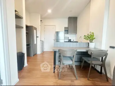 Modern kitchen with sleek cabinetry and dining area in stylish apartment