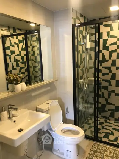 Modern bathroom with geometric tile shower and sleek fixtures