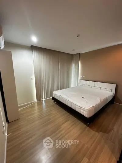 Spacious bedroom with modern design and wooden flooring