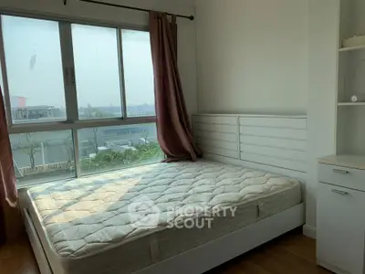 Bright bedroom with large window and modern furnishings