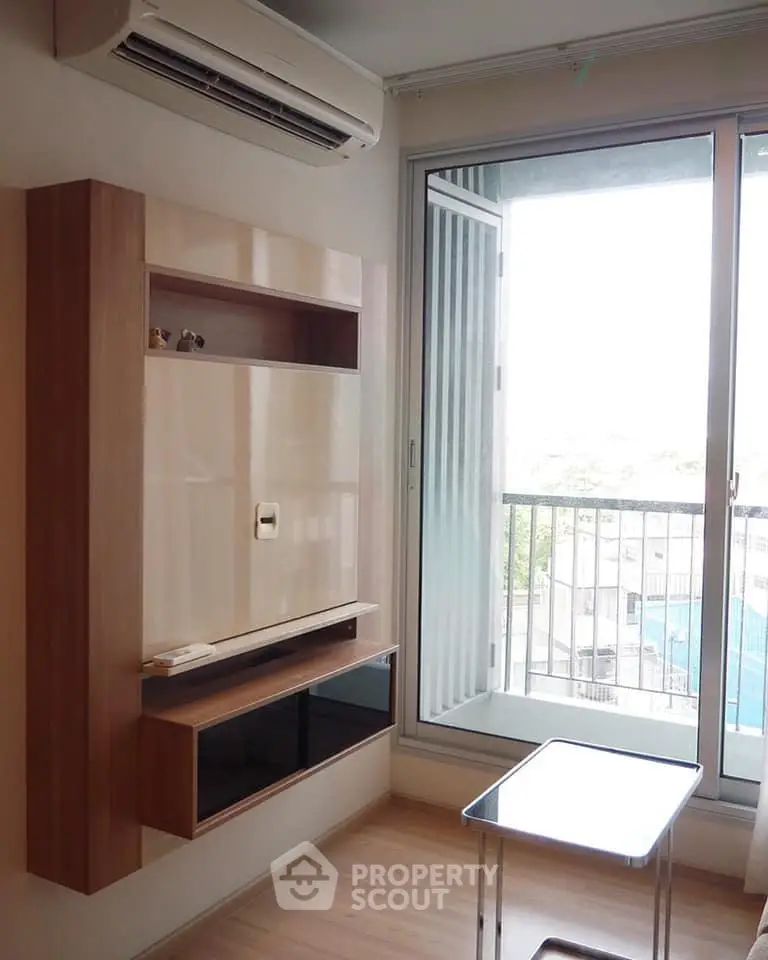 Modern living room with wall-mounted storage and balcony view