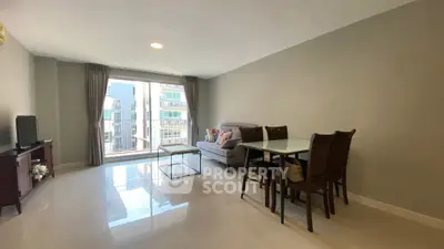 Spacious modern living room with large windows and elegant dining area.