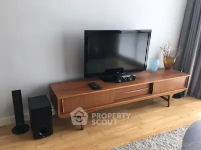 Stylish living room with modern TV setup on elegant wooden console.
