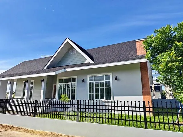 Charming single-story home with modern facade and lush green lawn, perfect for family living.