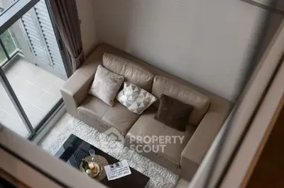 Modern living room with cozy sofa and balcony view