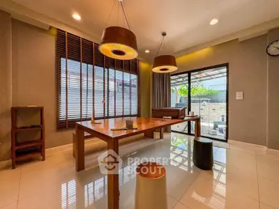 Spacious modern living room with stylish lighting and large windows