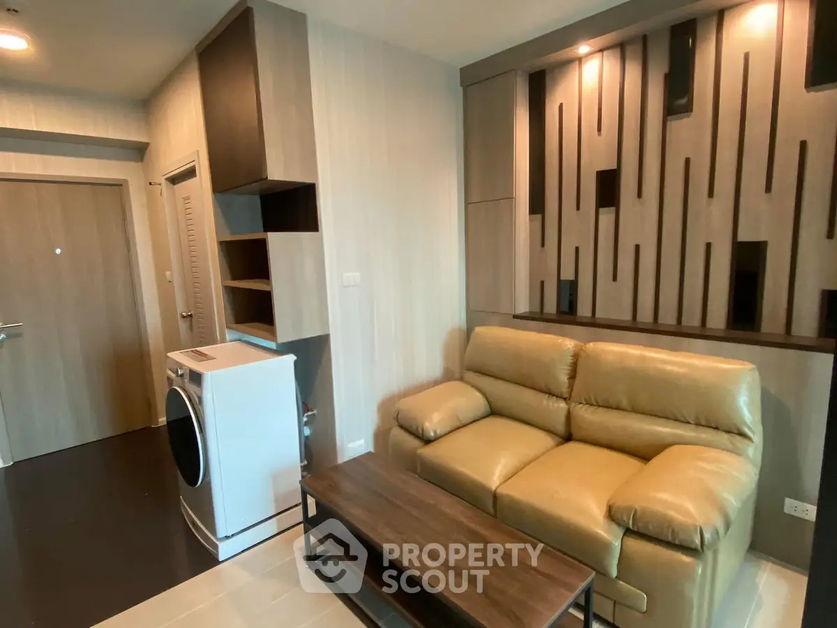 Modern living room with stylish decor and washing machine in a cozy apartment.
