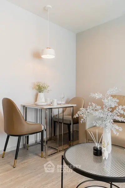 Stylish modern dining area with elegant chairs and table in a cozy apartment setting.