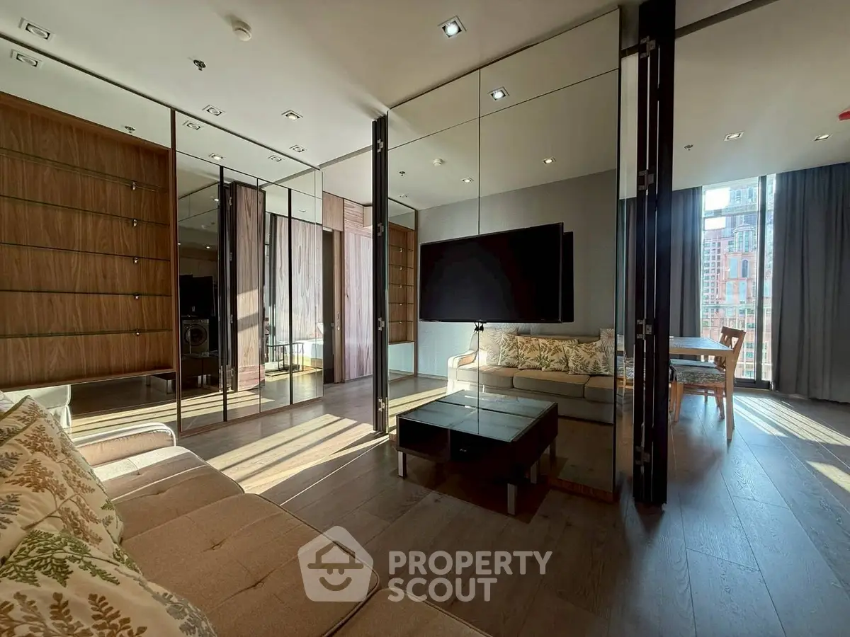 Luxurious modern living room with floor-to-ceiling windows and elegant furnishings in a high-rise apartment.