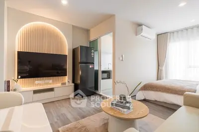 Modern studio apartment with stylish decor, featuring a cozy living area, compact kitchen, and elegant bedroom.