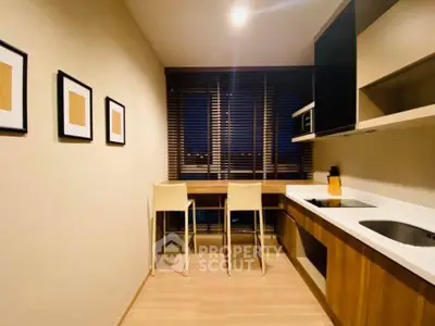 Modern kitchen with sleek design, featuring a breakfast bar and stylish wooden cabinetry.