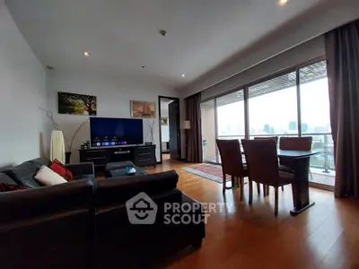 Spacious living room with modern decor and city view balcony in luxury apartment.
