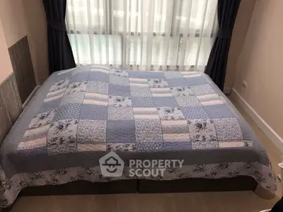 Cozy bedroom with large bed and elegant curtains, perfect for relaxation.