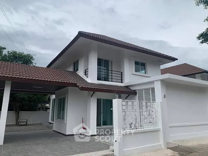 Charming two-story house with tiled roof and modern design in a serene neighborhood.