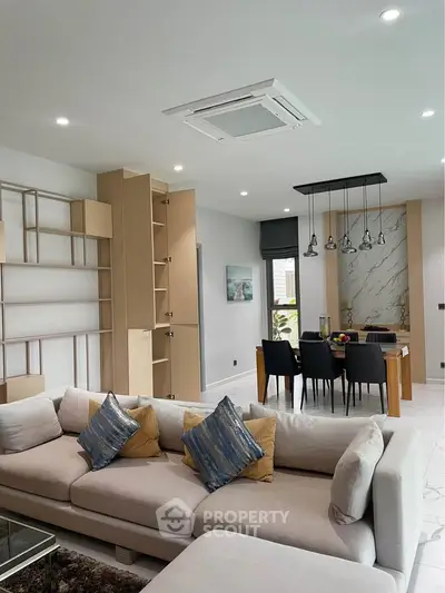 Modern living room with elegant dining area and stylish decor