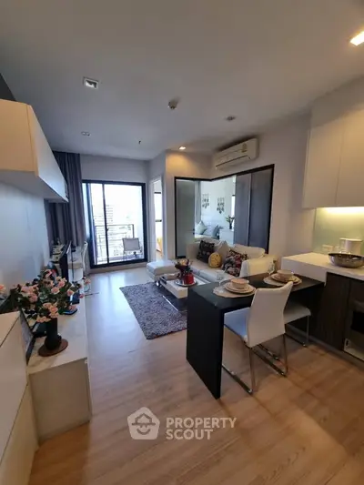 Modern open-plan living room with dining area and city view balcony.