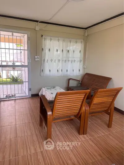 Cozy interior with wooden chairs and tiled floor, perfect for relaxation.