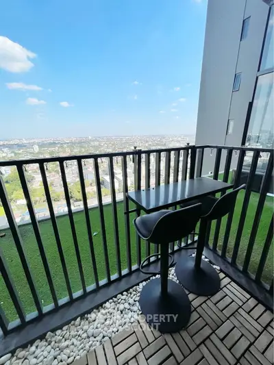 Stunning high-rise balcony with panoramic city views and modern outdoor seating.